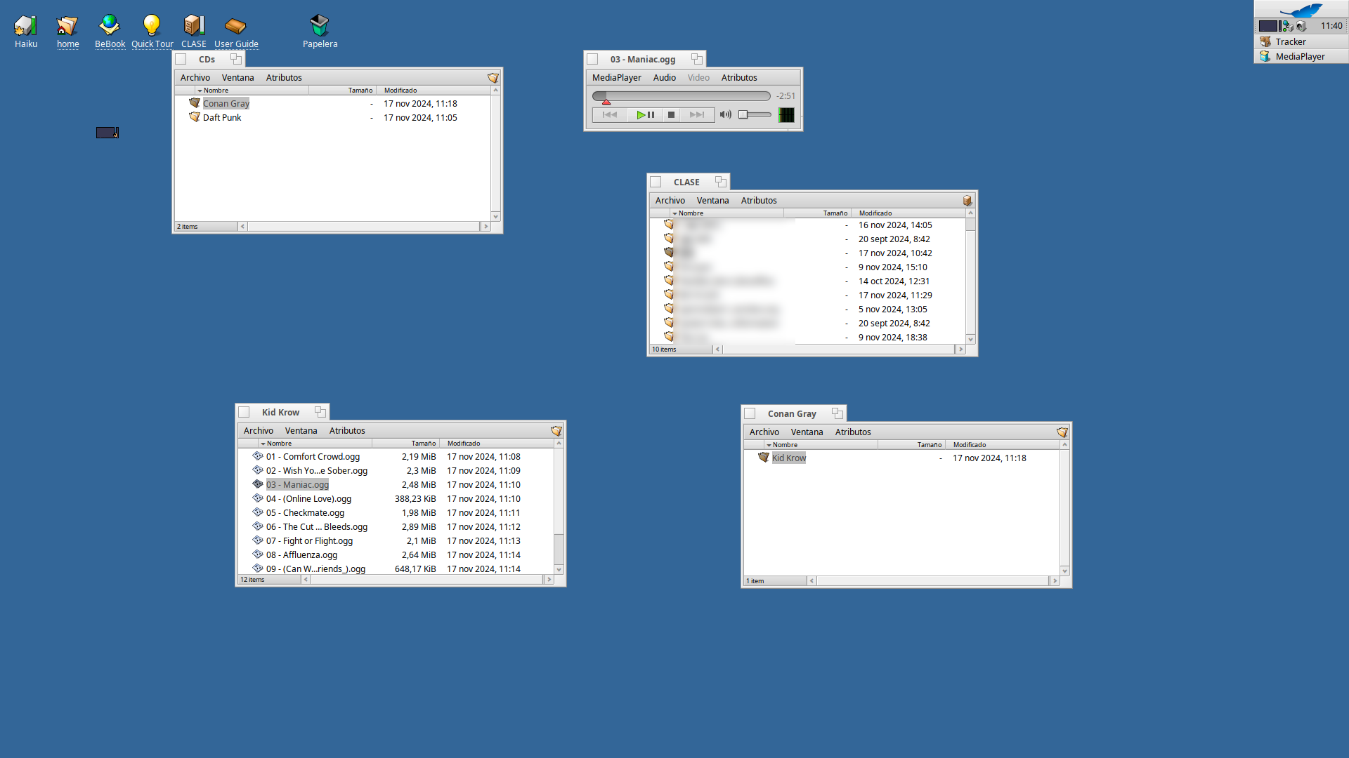 Screenshot of Haiku with various folders open and a music player