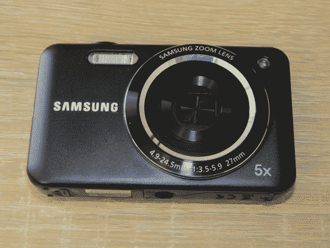 A picture of the camera. It has a black metal chasis and a retractable lens